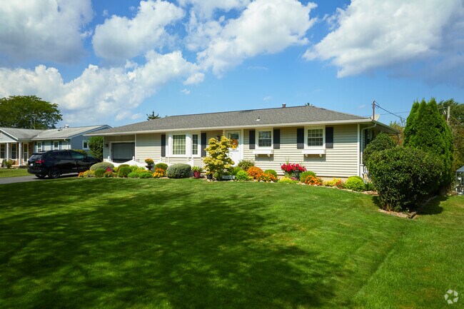 This quaint Hilton rancher uses landscaping for additional privacy.