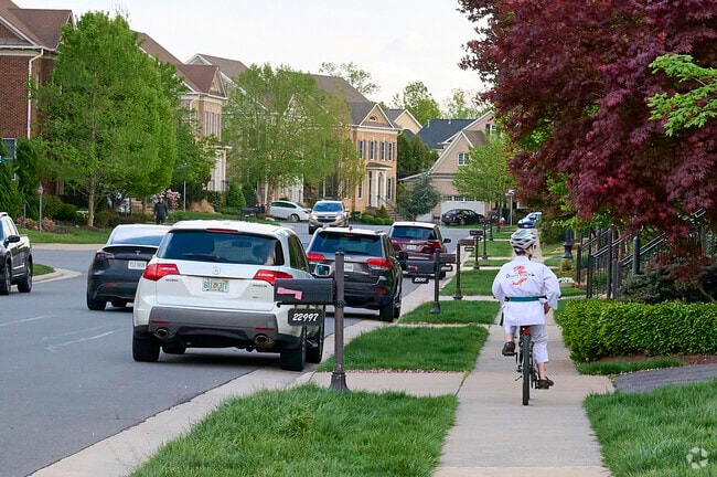 A karate student rides home down the tree-lined streets of Brambleton.