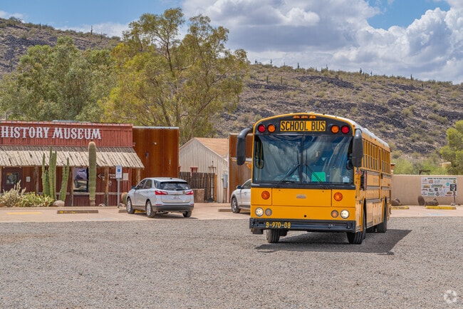 A school bus departing from the Pioneer Museum in North Gateway highlights the museum's role as a popular field trip destination, providing students interactive lessons in local history and Arizona's heritage.