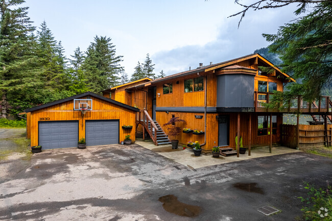 Large two-story homes in North Douglas line the mountainside, overlooking the scenic ocean.