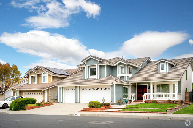 This blue home with porch and three car garage welcomes you to Diamond Bar.