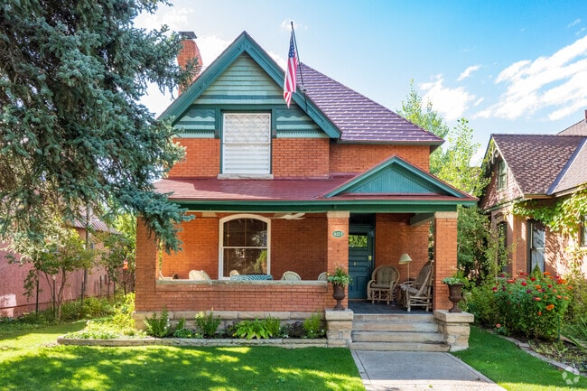 Some home feature front porches and sitting areas as well as grass lawns.
