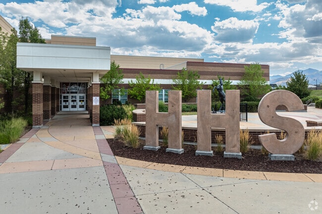 Large concrete letters HHS decorate the courtyard at Herriman High School.