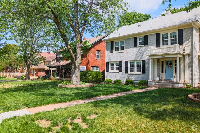 Grey brick home next to a red brick home in Sleepy Hollow.