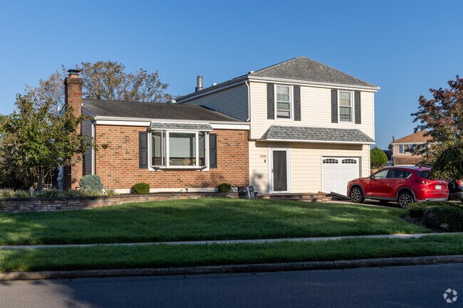 Split-level homes with neat landscaping sit on a large lot in Neshaminy Valley.