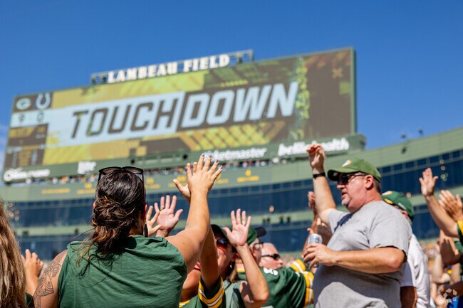 Astor residents celebrate Packer touchdowns at Lambeau Field.