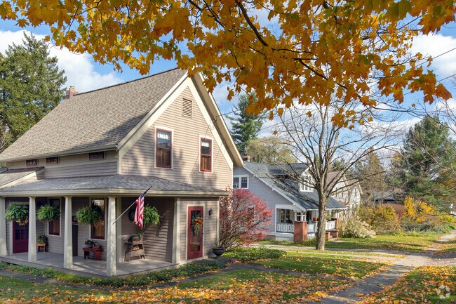 An eclectic row of homes in a Richfield neighborhood surrounded by fall foliage.