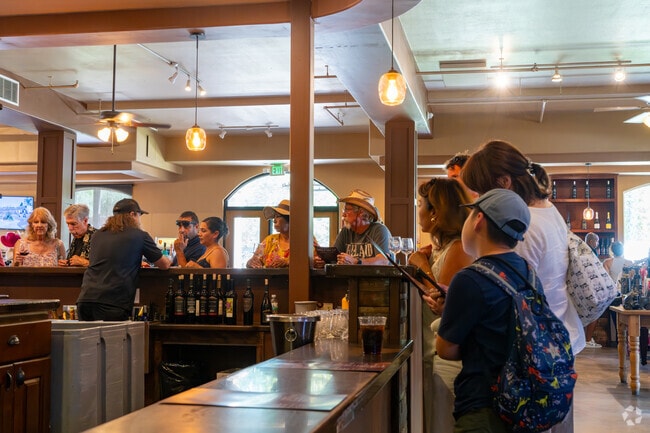 Indoor wine tasting scene at Wilson Creek Winery with guests enjoying local vintages.