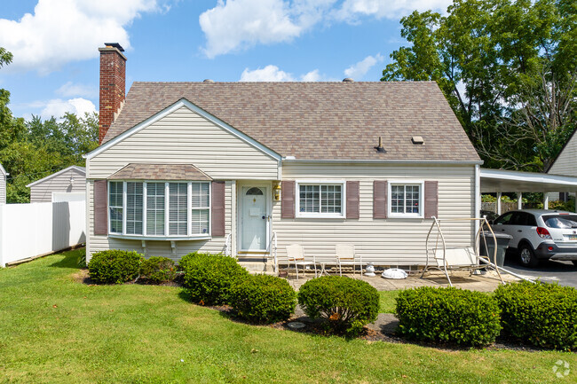 A cape cod home in Holly Hill has beautiful landscaping.