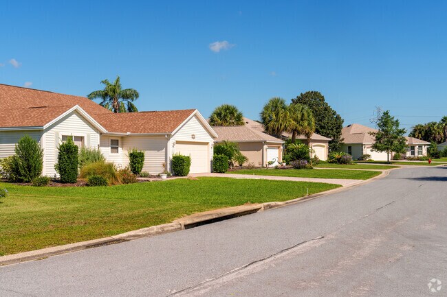 A row of homes in the Village of Palo Alto features exemplary landscaping.