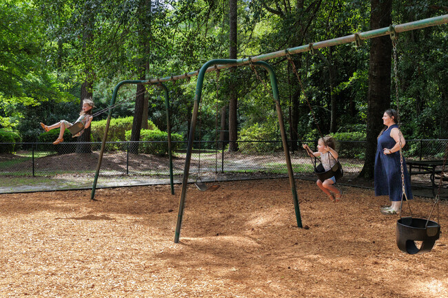 Parents love spending time at the shaded playground on warm days at Swan Lake Playground.
