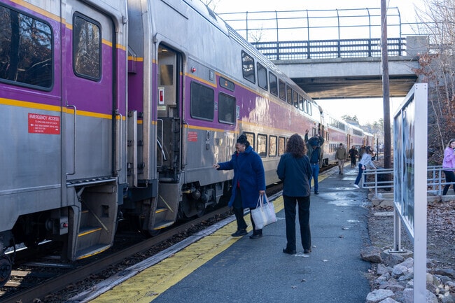 Passengers board the MBTA Commuter Rail at Wellesley Square station.