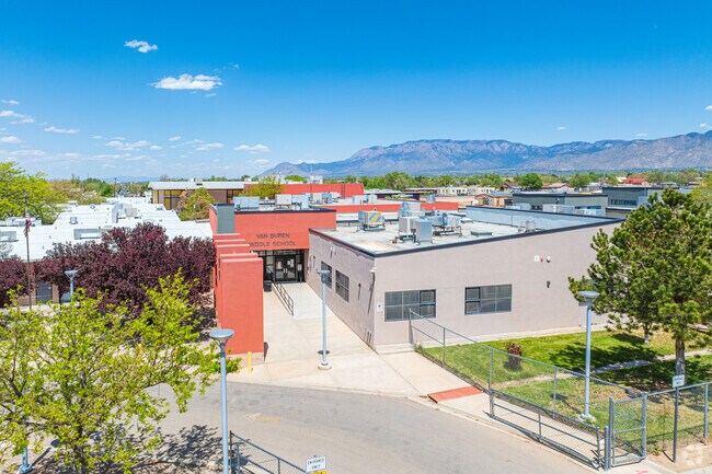 Van Buren Middle School's front entrance and the Sandia Mountains in the distance.