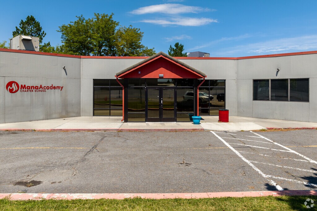 Mana Academy Charter School is made of cement with red details.