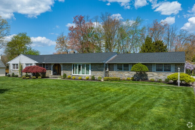 Modest rancher with stone features and a large yard in Berlin.