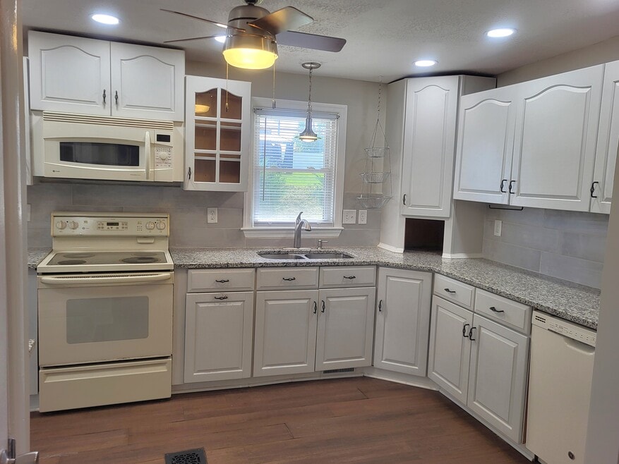 Large kitchen with lots of storage and granite counters