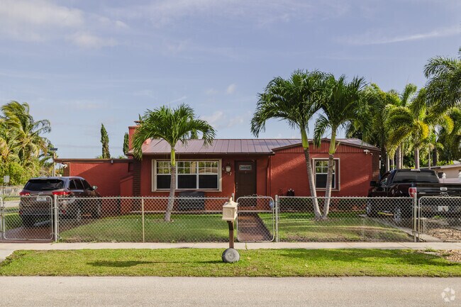 Colorful ranch home shaded by palm trees in Grandview Heights.