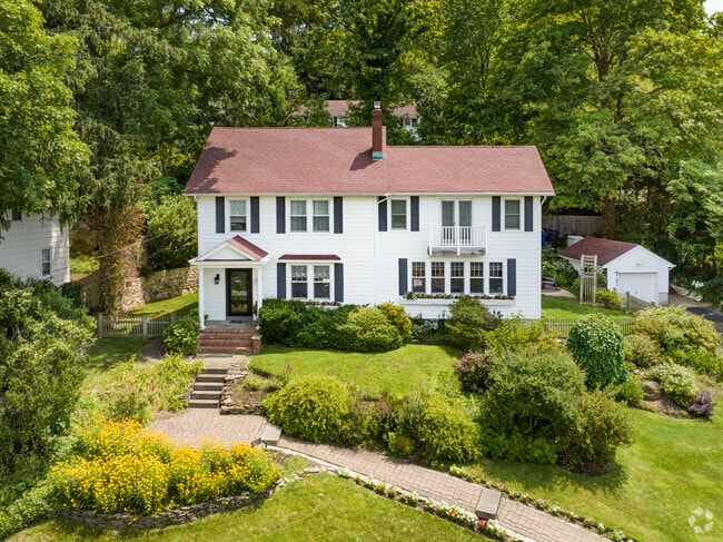 Dutch Colonial architecture adds timeless charm to this Laurel Hollow home with harbor views.