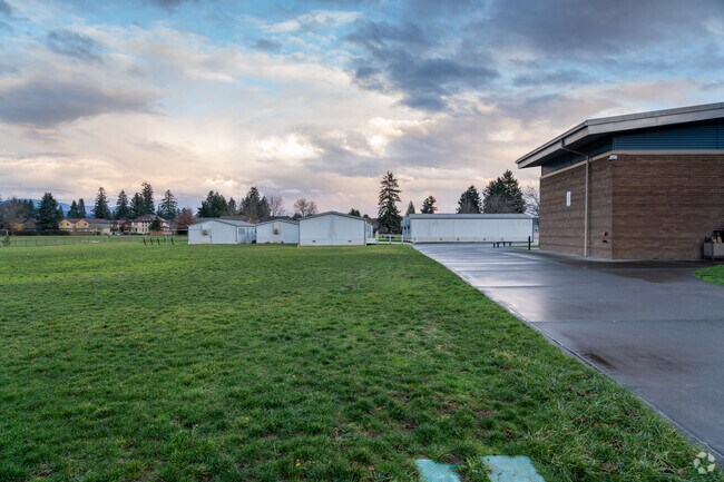 Playing field and satellite classrooms behind the school.