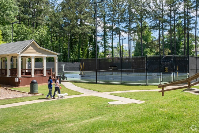 Residents of Medlock Bridge enjoy shaded walking paths, a community pavilion, and tennis courts nestled among tall pines.