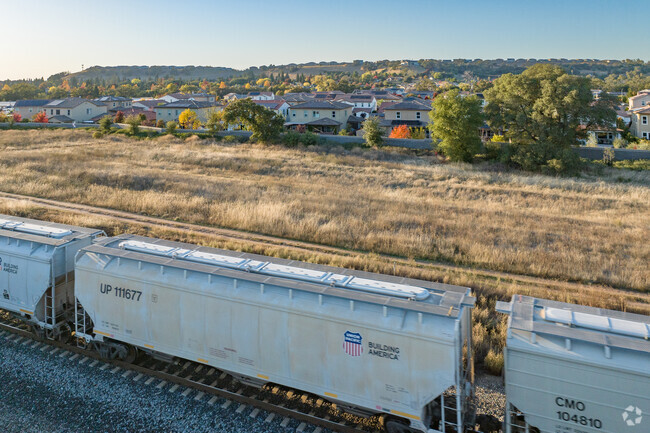 A freight train passes under the view of Mission Hills.