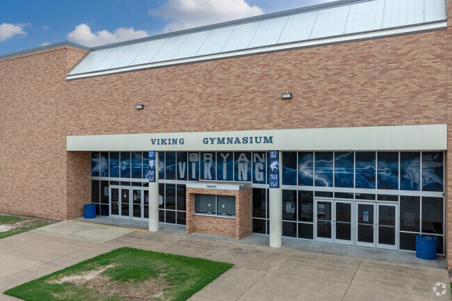 Engage in spirited play at Bryan High School's gymnasium.