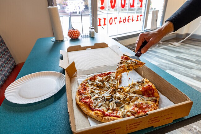 The Pizza Plug piles on the toppings for Brownsville foodies.