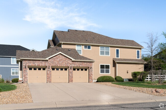 This stunning beige modern brick home in The Haven at York Street features sleek design, a spacious 3-car garage, and elegant curb appeal in a quiet, upscale neighborhood.