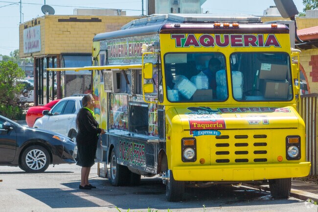 Man enjoys tacos from a food truck in the vibrant Magic Circle neighborhood.