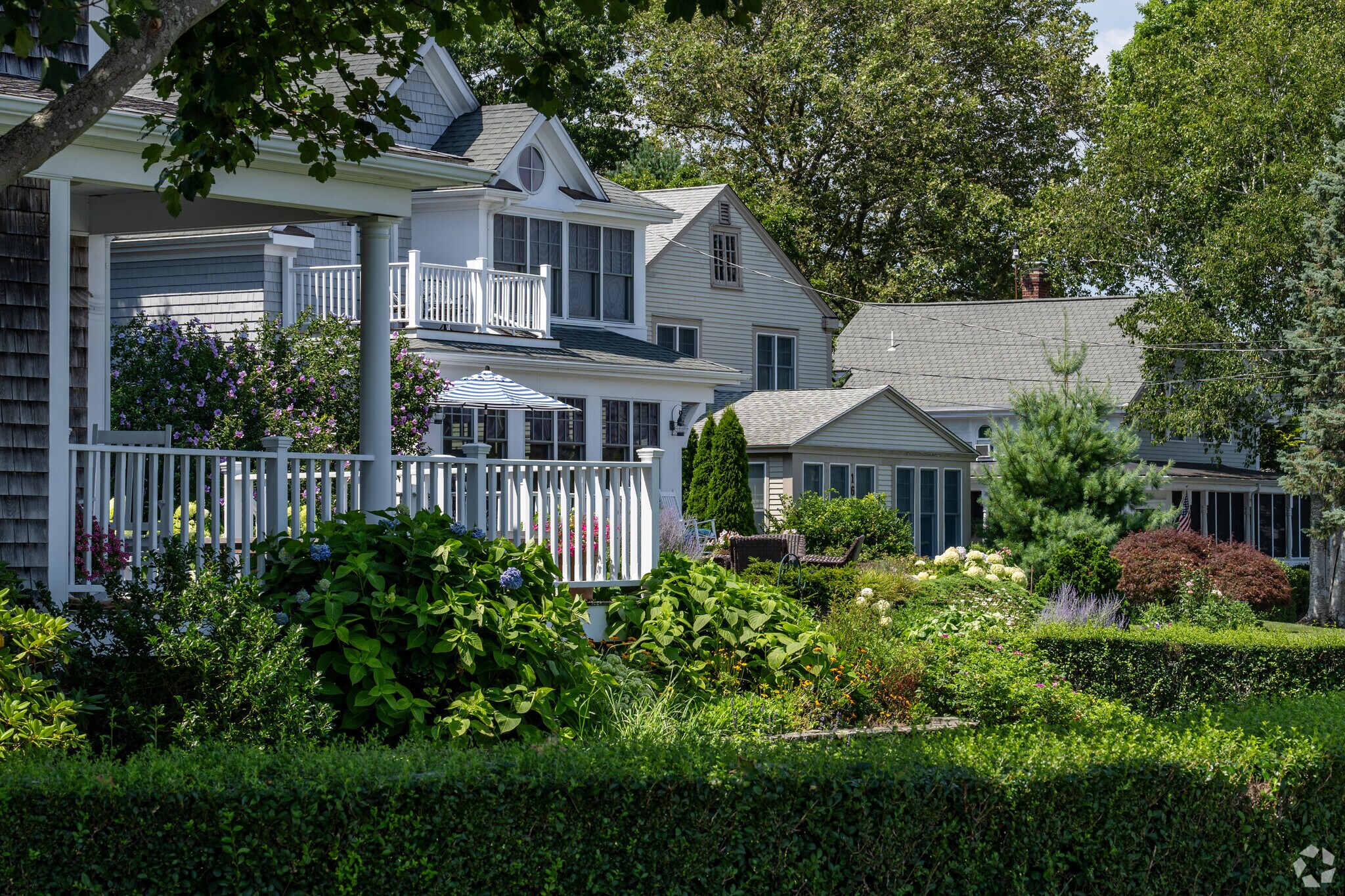 This row of modest homes in the Rumstick neighborhood have mature plantings and water views.