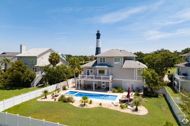 Homes throughout the island feature swimming pools and views of the historic lighthouse.