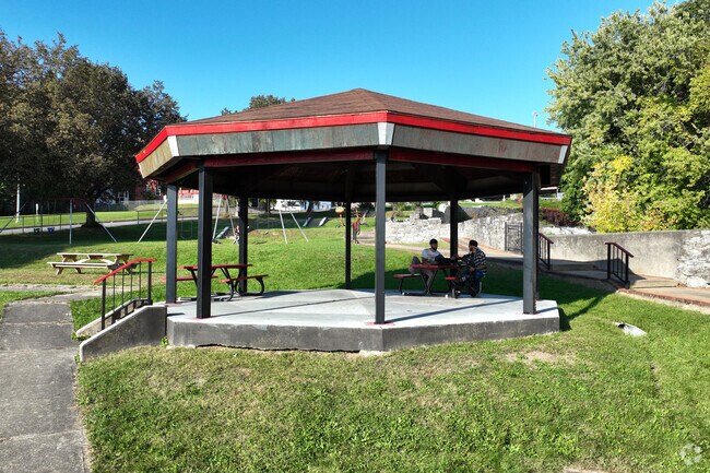 A gazebo is present at the park to get some shade and enjoy the sunny day a bit longer.