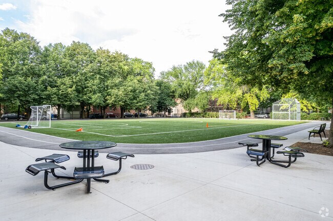 Outdoor tables overlook the soccer field at Pulaski International School.