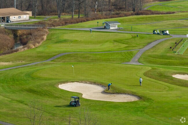 Golfers enjoy the sunny weather on the course in East Amherst.