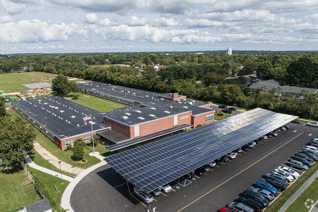Showing the front parking lot with solar car ports.
