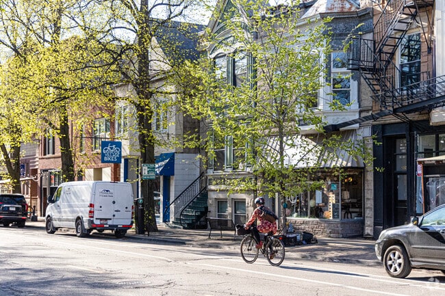Shops and homes line the streets of Roscoe Village as bikers whiz by.