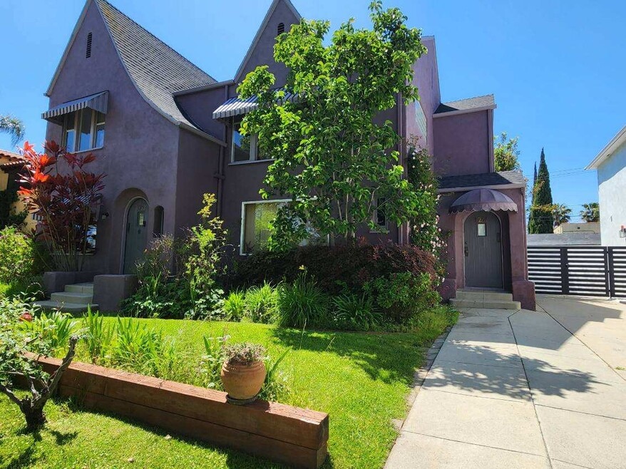 Front entrance for upper unit on right under awning.
