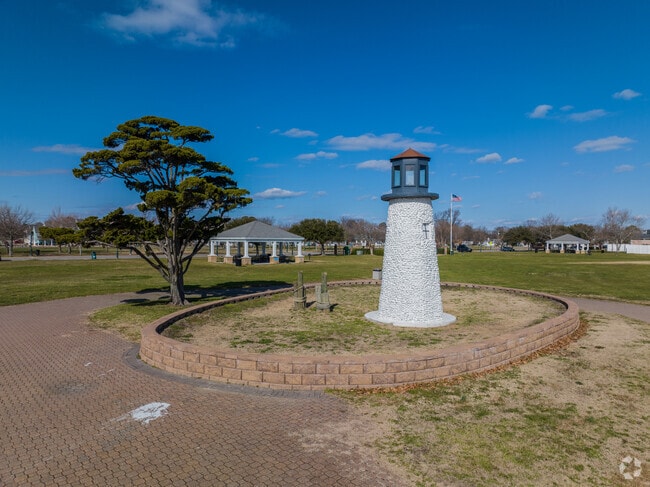 Buckroe Beach has a land light house on display near the water.