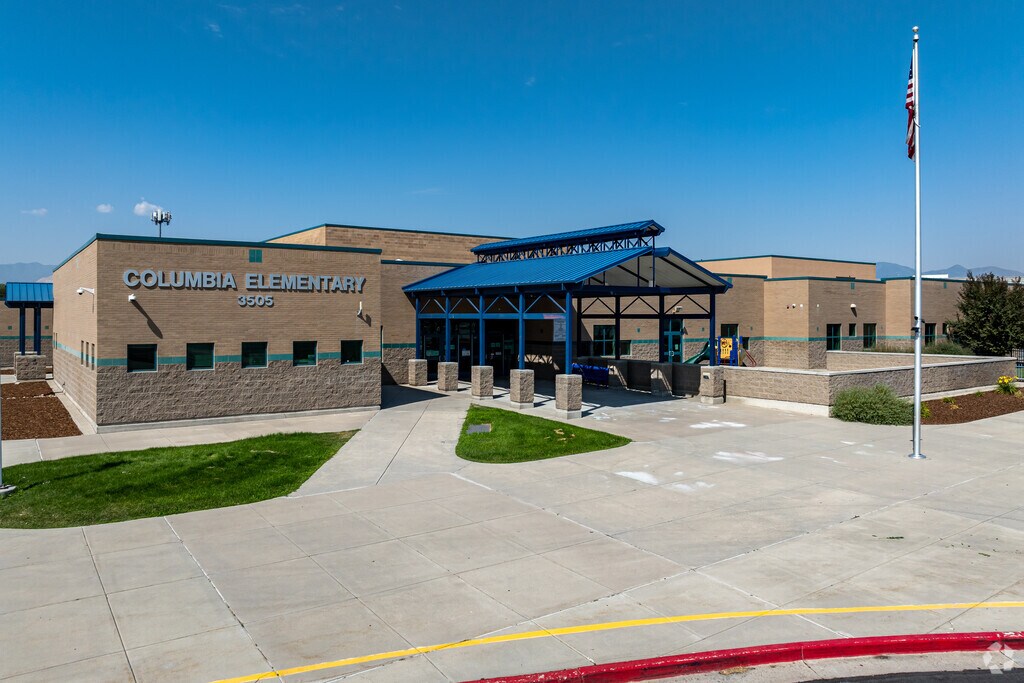 A long blue awning shades the entrance at Columbia Elementary School.
