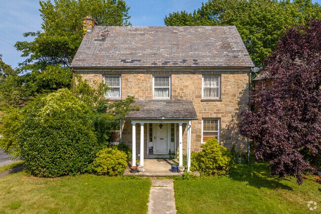 Stone colonial revival homes in Violet Hill have large yards perfect for summer BBQs.