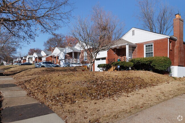 Greendale houses have space for one car in the driveway and a tree in the yard.