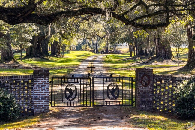 A Cordesville private ranch welcomes its residents with a wrought iron gate.