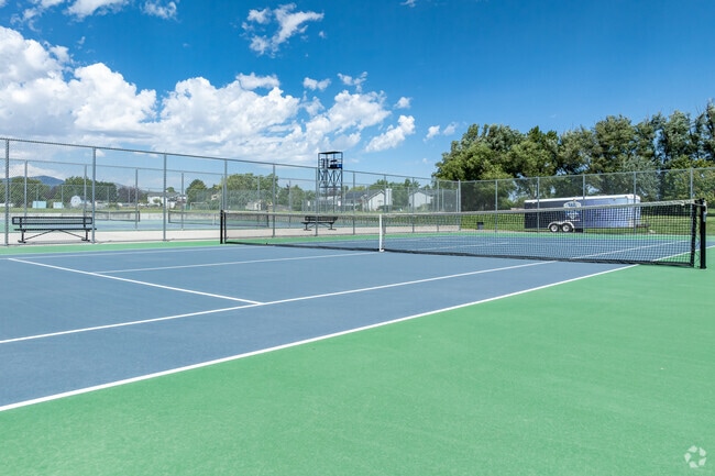 Blue skies and green trees echo the colors of the tennis courts at West Jordan High School.