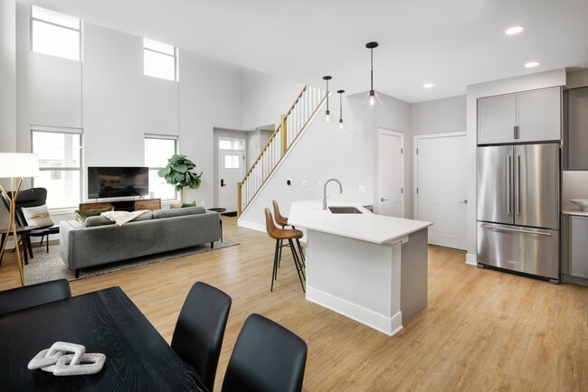 Signature Collection Townhome kitchen, dining, and living room with hard surface flooring