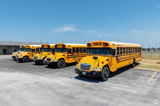 Bright yellow school buses are lined up at Tolar High, ready to safely transport students.