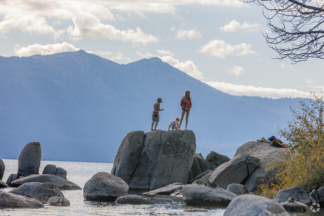 Children play upon the many boulders scattered across Lake Tahoe's shoreline.