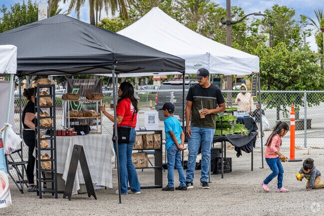 Customers explore some of the baked items at the Wrigley Farmer's Market in Long Beach.