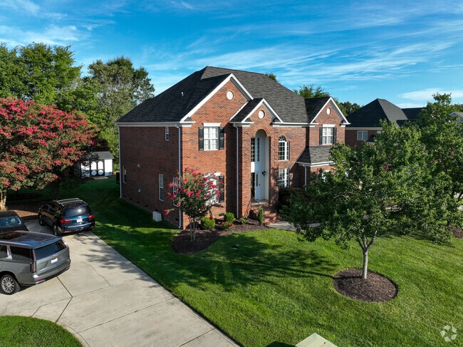 Shade from mature trees cover a bit of this brick home in Mallard Creek-Withrow Downs