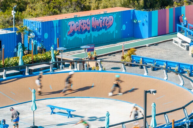 Skaters scale the roller derby wall as Derby United in Encanto.
