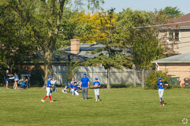 A youth baseball team practices on the baseball field at Jonquil Park.